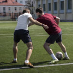 full shot men playing soccer